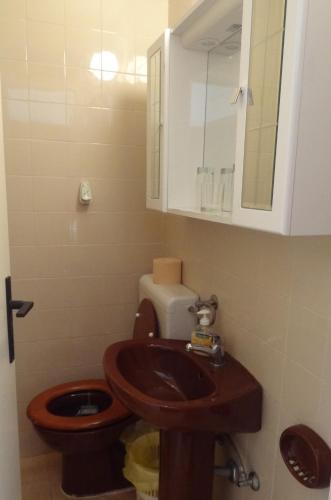 a bathroom with a wooden sink and a toilet at Inn Town Center in Hvar