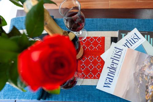 a table with a red rose and a glass of wine at Sapa Passion Hotel & Spa in Sa Pa
