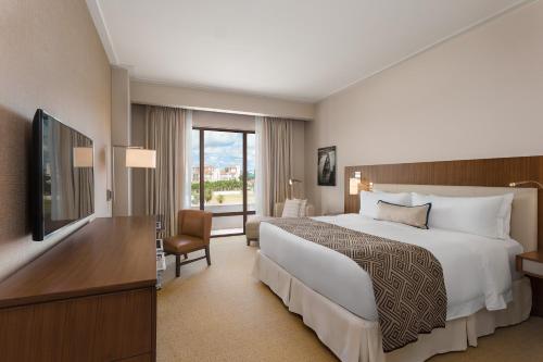 a hotel room with a bed and a television at The Santa Maria, a Luxury Collection Hotel & Golf Resort, Panama City in Panama City