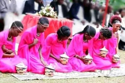 a group of women in pink shirts kneeling down at Kibale Cultural Homestay in Fort Portal