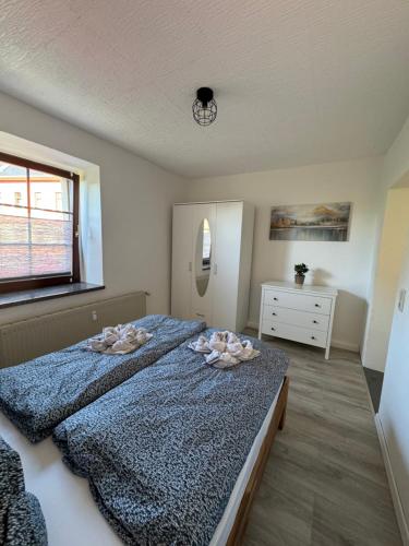 a bedroom with a bed with two pillows on it at Erzgebirgsglück Jöhstadt EG in Jöhstadt