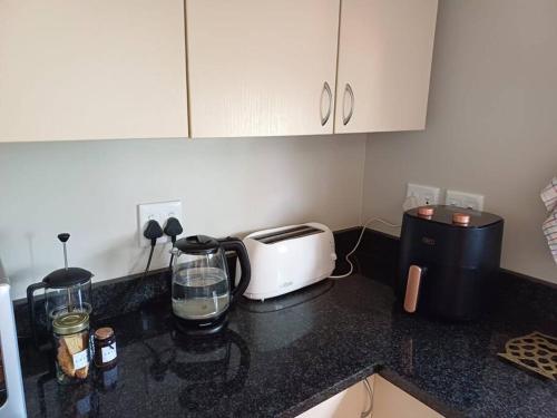 a kitchen counter top with a toaster and a toaster at The Loft in Mtunzini