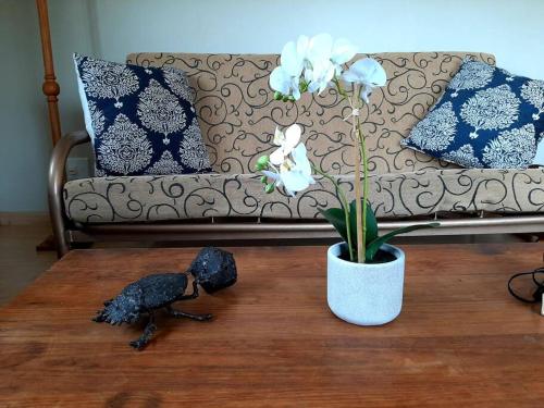a bird statue on a coffee table next to a couch at The Loft in Mtunzini