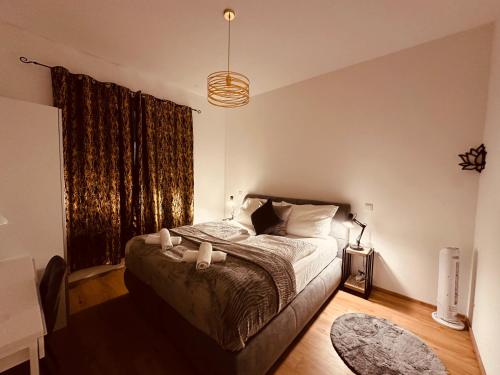 a bedroom with a bed and a large window at Schönbrunn Garden Apartments in Vienna