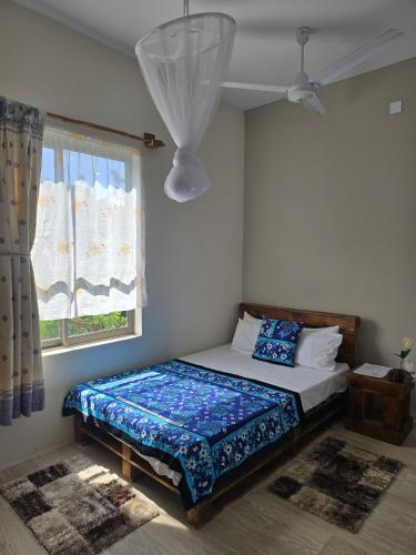a bedroom with a bed and a window at The Vipingo Retreat in Vipingo