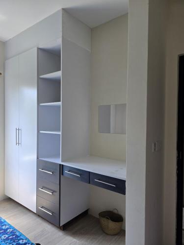 a closet with white cabinets and a counter at The Vipingo Retreat in Vipingo