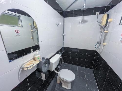 a bathroom with a toilet and a shower at ACF Guest House in Sungai Lembing