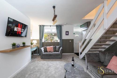 a living room with a staircase and a couch at Luke Stays- Newton Hall Cottage in Durham