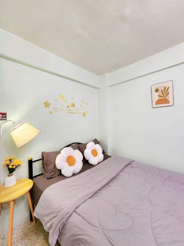 a bedroom with a bed with flowers on it at 803-STP Homely room Free Wi-Fi and Near BTS line in Bangkok