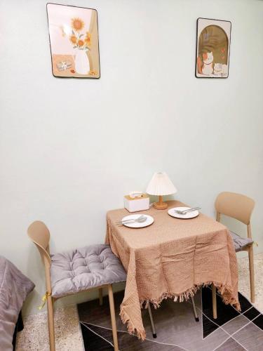 a table with a table cloth and two chairs at 803-STP Homely room Free Wi-Fi and Near BTS line in Bangkok