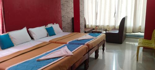 two beds sitting in a room with at yelagiri residency in Yelagiri