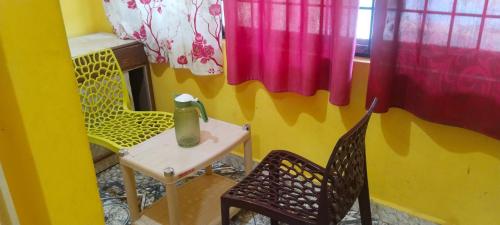a small room with a table and two chairs at yelagiri residency in Yelagiri