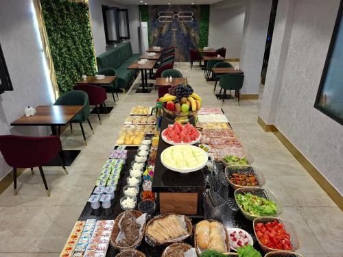 a buffet of food on a long table in a restaurant at My Status Hotel in Tashkent