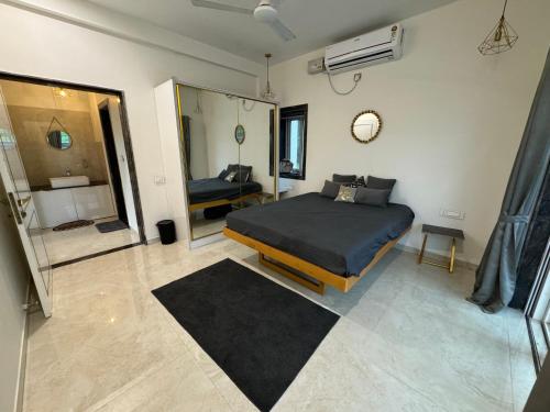 a bedroom with a bed and a mirror at Prana Healing House in Pune