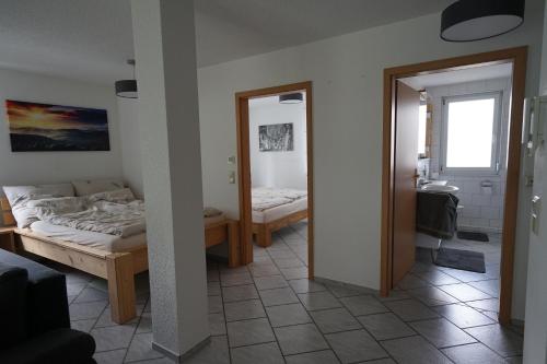 a bedroom with two beds and a mirror at Ferienwohnung mit gemütlicher Terrasse im Nordschwarzwald in Oberreichenbach