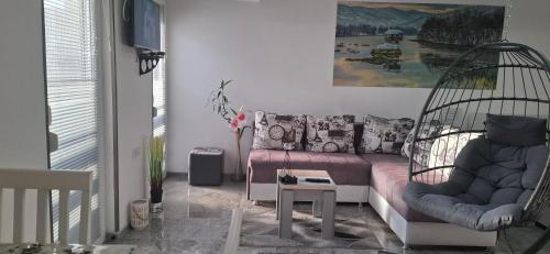a living room with a swing and a couch at APARTMENTS IVANOViC CENTER CITY in Bajina Bašta