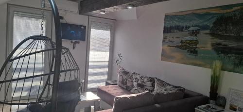 a living room with a couch and a swing at APARTMENTS IVANOViC CENTER CITY in Bajina Bašta