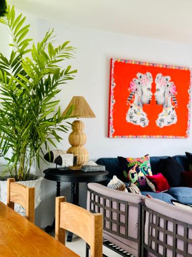 a living room with a couch and a table at Villa Think Of Home in Khao Lak
