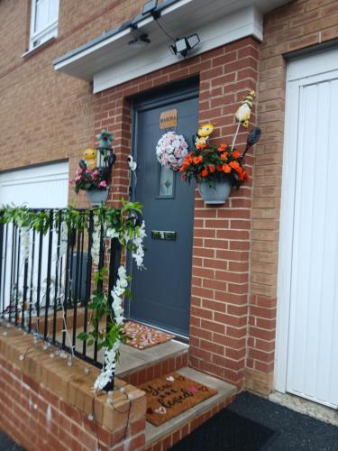 a front door of a house with flowers in pots at Marina & Seagulls in East Cowes