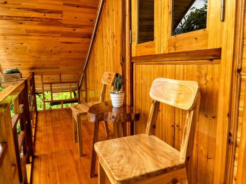 a room with chairs and a table in a cabin at The cosy nest of happiness! in Lao Cai