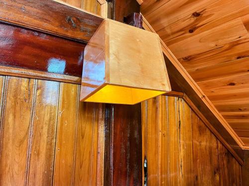 aendant light hanging from a wooden wall at The cosy nest of happiness! in Lao Cai