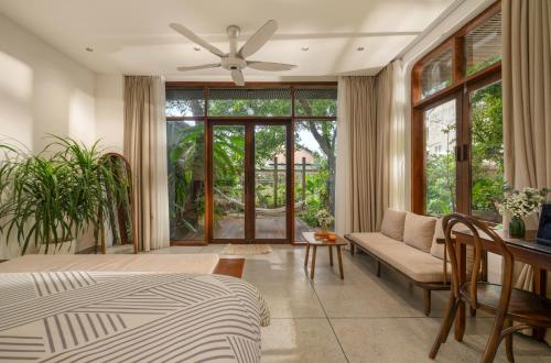 a bedroom with a bed and a ceiling fan at Forest Tag Homestay in Hue