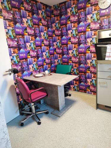 an office with a table and chairs in front of a wall at Apartment Walnuss in Katlenburg-Lindau
