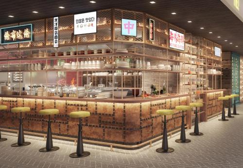 a restaurant with a bar with yellow stools at Andaz Doha, by Hyatt in Doha