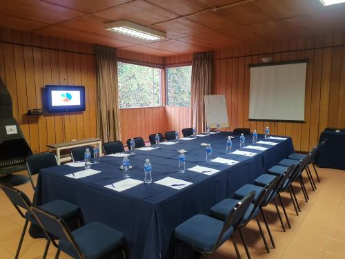 a long table in a room with chairs and a screen at Kings Lodge Hotel in Hogsback