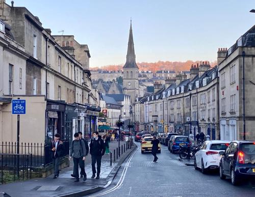 a group of people walking down a city street at Elegant & Romantic - Entire Flat with 2 Magnificent Views in Bath