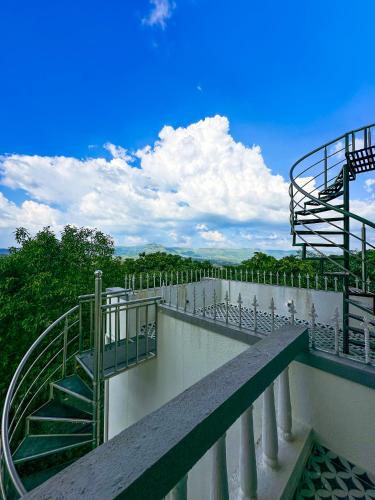 a balcony with stairs on top of a building at Prana Healing House in Pune
