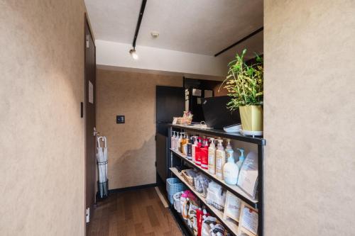 a walk in pantry with a shelf full of food at Hotel Akasaka Heights in Fukuoka
