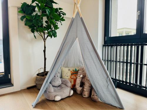 a teepee tent in a room with stuffed animals at Dora o wellness o mountainview o lake Lucerne in Ingenbohl