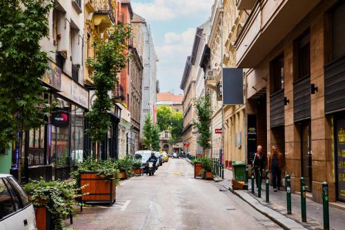 a city street with buildings and people walking down the street at City Sky Lodge in Budapest