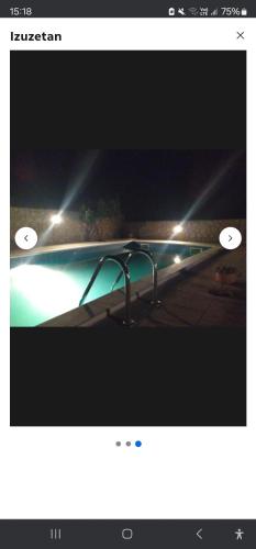 a picture of a swimming pool at night with lights at Apartments Kalac in Posedarje