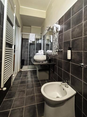 a bathroom with a toilet and a sink at B&B Aquino in Terrazza in Aquino