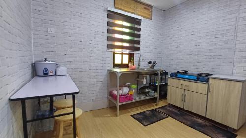 a kitchen with a sink and a counter in a room at HOMESTAY ANAK SYURGA AMzAR MALAY ONLY in Kangar