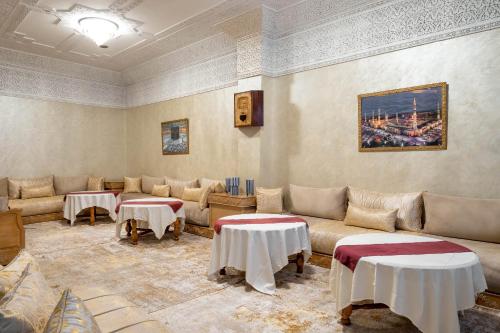 a living room with couches and tables in a room at Hotel Casablanca City Center in Casablanca
