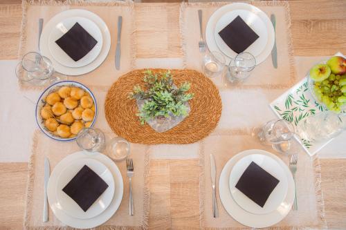 a table with plates and bowls of food on it at KIŽIN House, Cozy apartments by Istrian Embrace in Brezovica pri Gradinu