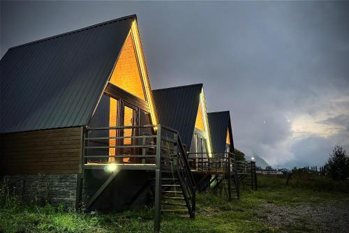 a row of houses with a staircase in front of them at Cottages DILA in Stepantsminda