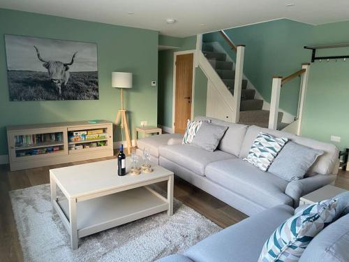 a living room with a couch and a table at The Barn in Swanmore