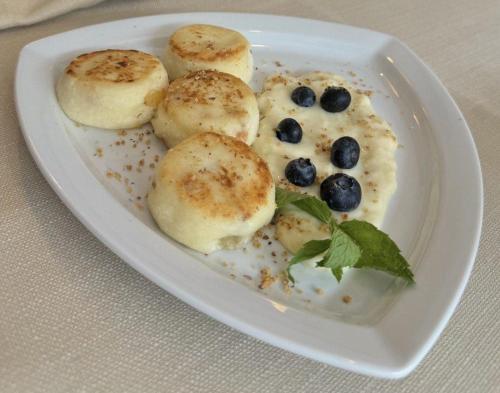 a plate of food with biscuits and blueberries on a table at Хостел & Ресторан Сommunity & change the world in Dnipro