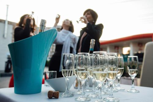 a table with wine glasses and a blue bucket on it at Хостел & Ресторан Сommunity & change the world in Dnipro