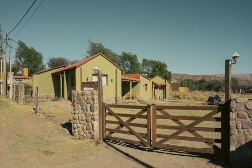 a wooden gate in front of a house at Cabañitas EL REPOSO HUMAHUACA in Humahuaca