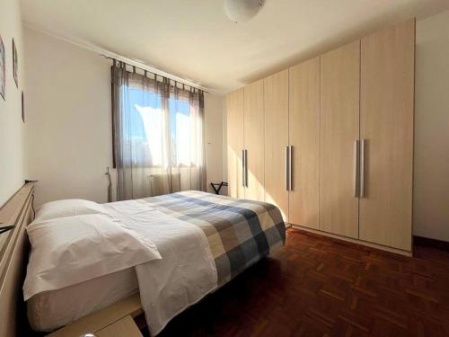 a bedroom with a bed and a large window at MIKY'S HOME in Castenaso