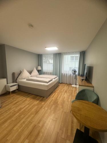 a large bedroom with a bed and a wooden floor at City Appartement am Hauptbahnhof in Nürnberg
