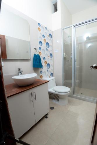 a bathroom with a toilet and a sink and a shower at Suchiche Park in Tarapoto