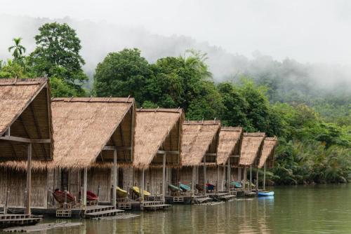 a row of huts on the water on a river at Thansur Tatai Eco Resort in Tatai