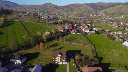 an aerial view of a small village in the mountains at Pensiunea La Bucovina in Mănăstirea Humorului