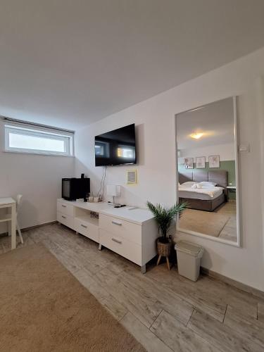 a white bathroom with a sink and a mirror at Comfort Rooms Remiza - Free Private Parking - Self check-in in Zagreb